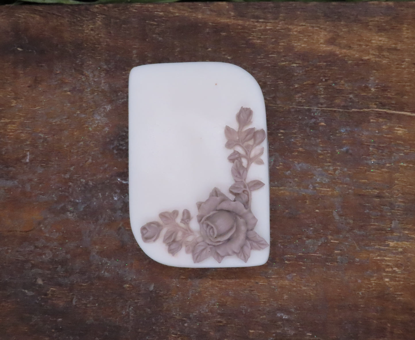 white bar with brown rose goat milk soap