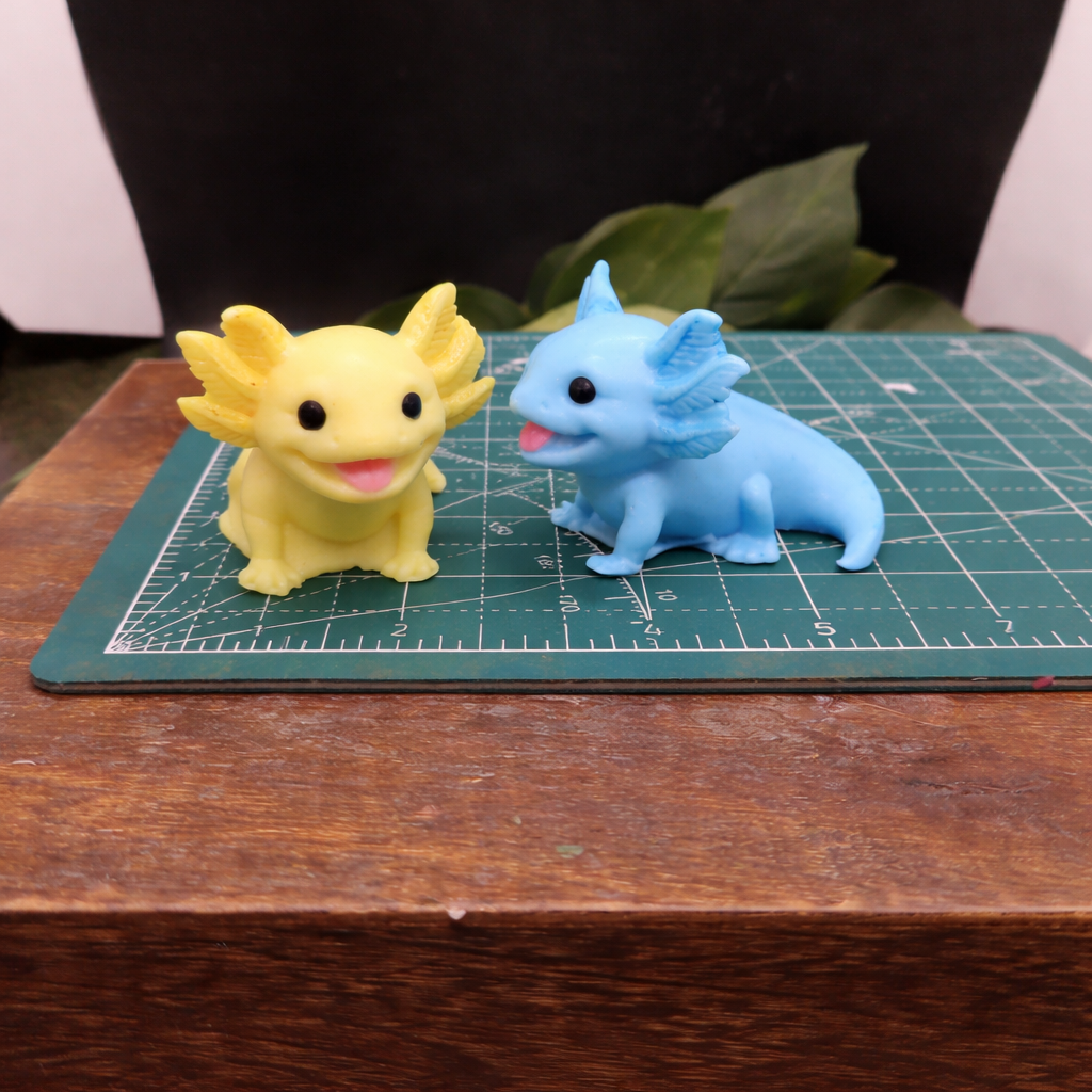 Yellow and blue axolotl goat milk soap keepsake gift, individually handcrafted collectible animal soap displayed on cutting mat for size