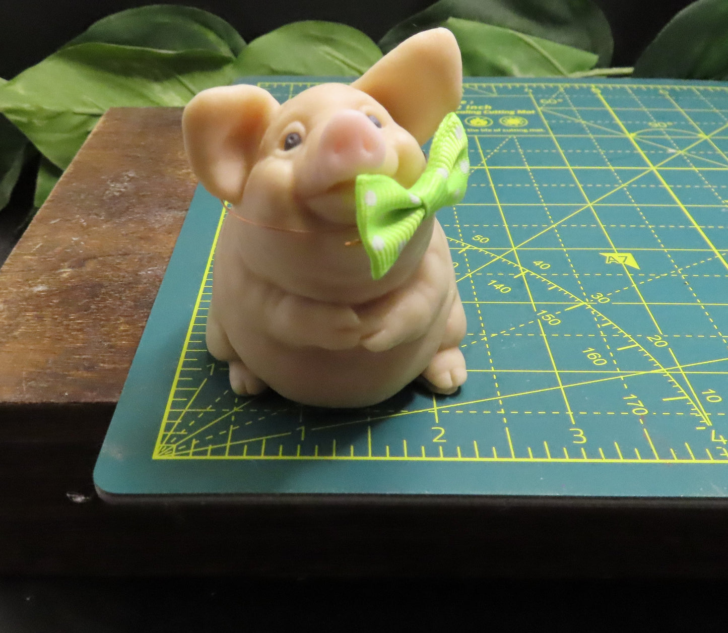 image of handmade pig goat milk soap on cutting mat showing dimension of approximately 1.5 inches wide.