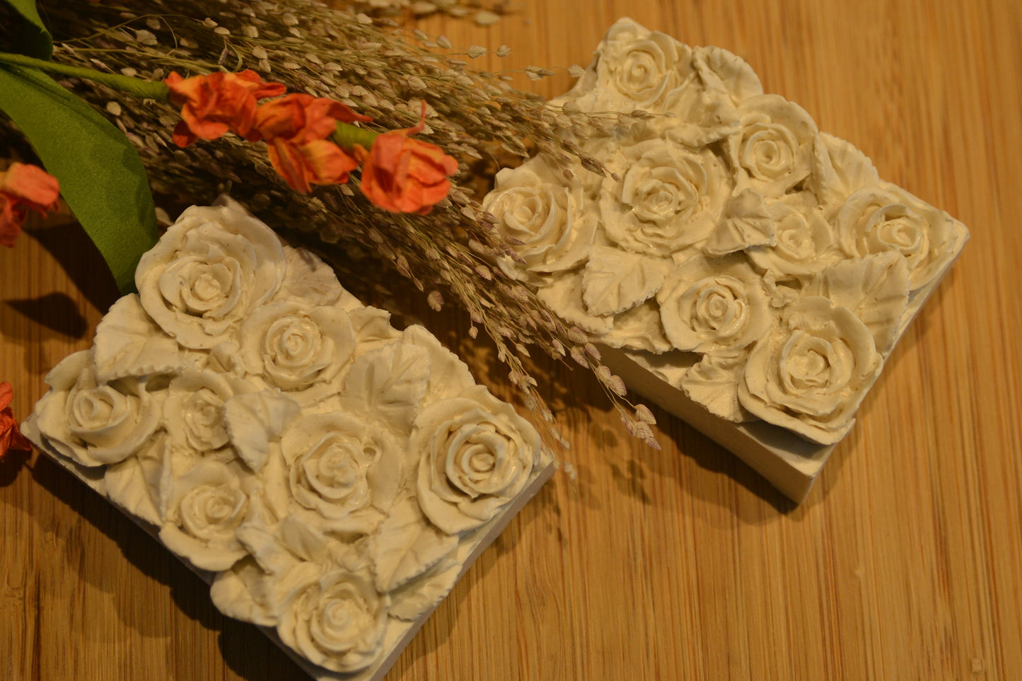 Set of 2 beautifully detailed handmade goat milk soap bars. Image of 2 light brown bars
