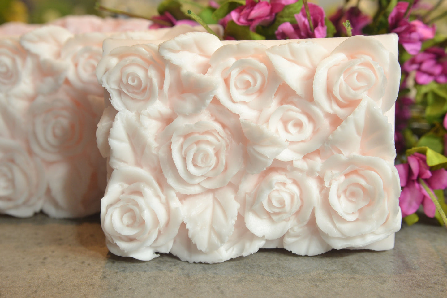 Set of 2 beautifully detailed handmade goat milk soap bars. Image of pink.