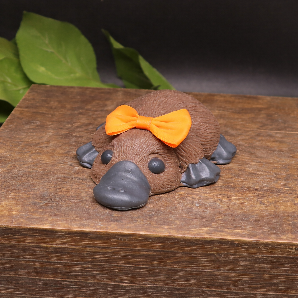 Close up detail of handmade platypus soap texture and bow, artisan goat milk novelty soap