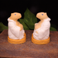 Handmade Goat Milk Budda Capybara soaps sitting on a wooden box facing each other. 