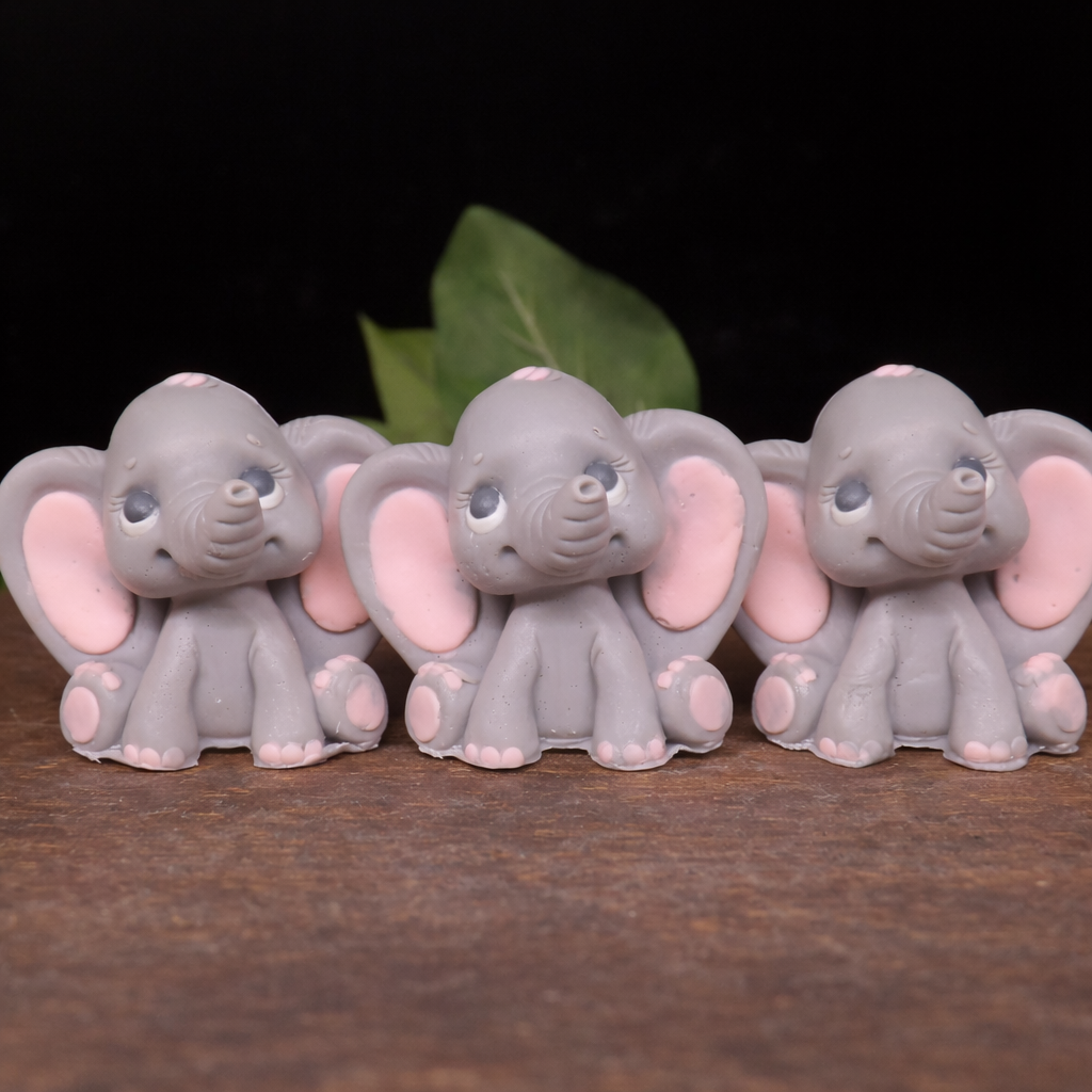 Handmade elephant goat milk soap with soft gray body and pink ears, individually handcrafted animal soap gift with detailed sculpting and smooth creamy finish on clean white background