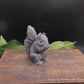 Handmade gray squirrel soap in speak no evil pose, crafted from goat milk soap as a whimsical decorative animal bath bar.