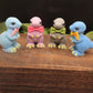 A group of mini t-rex goat milk soaps in different positions