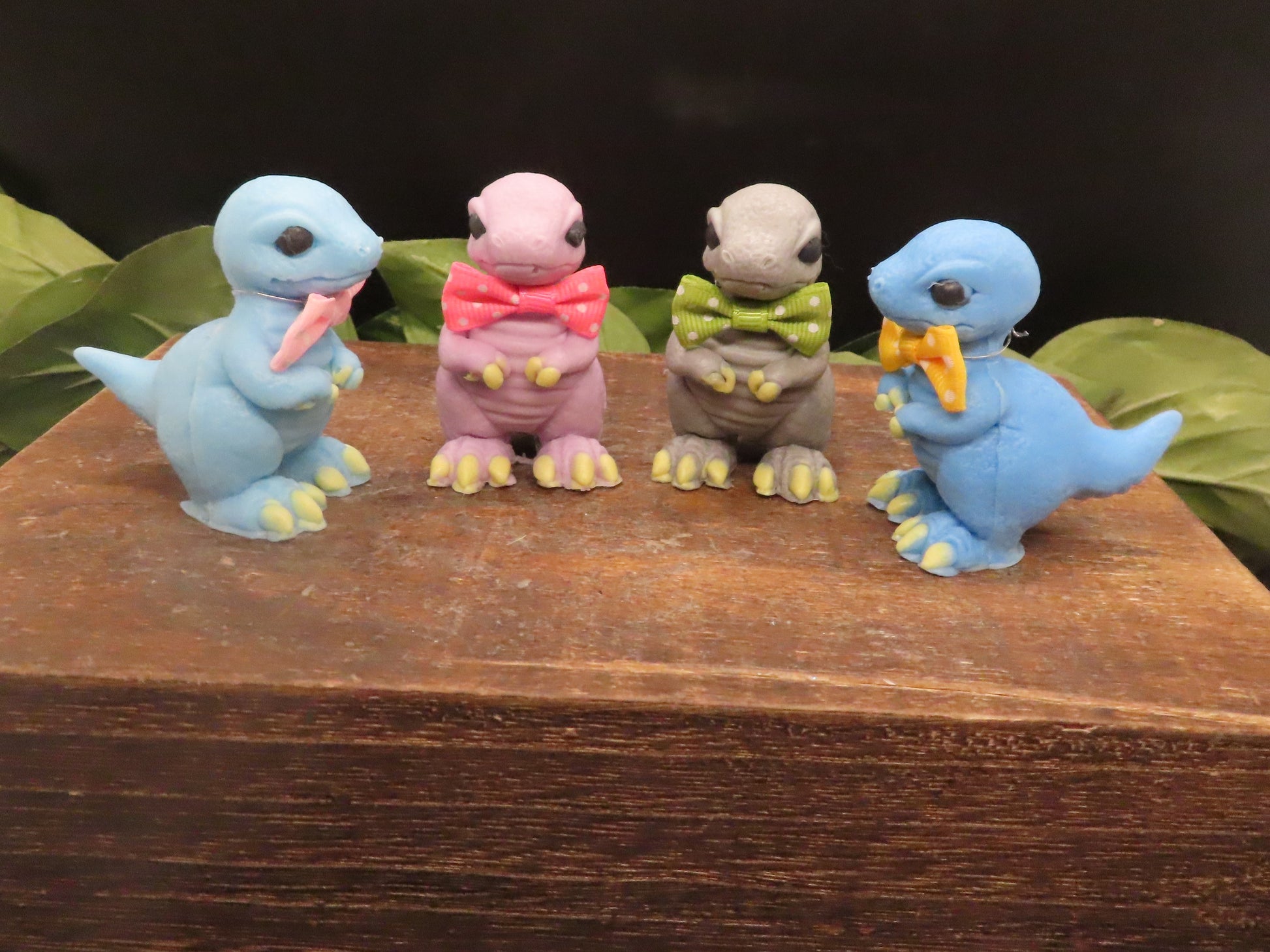A group of mini t-rex goat milk soaps in different positions