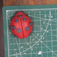 Ladybug goat milk soap measures approximately 2 x 2.5 inches