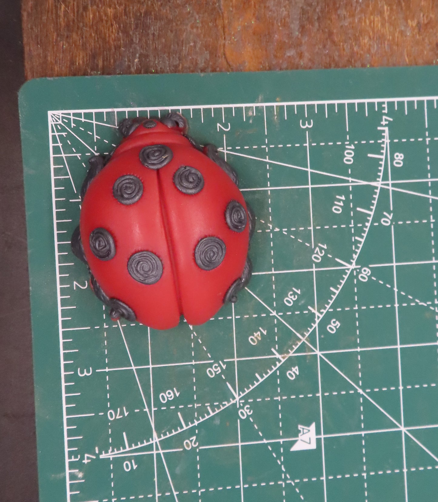 Ladybug goat milk soap measures approximately 2 x 2.5 inches