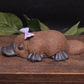 Side view Close up detail of handmade platypus soap texture and bow, artisan goat milk novelty soap