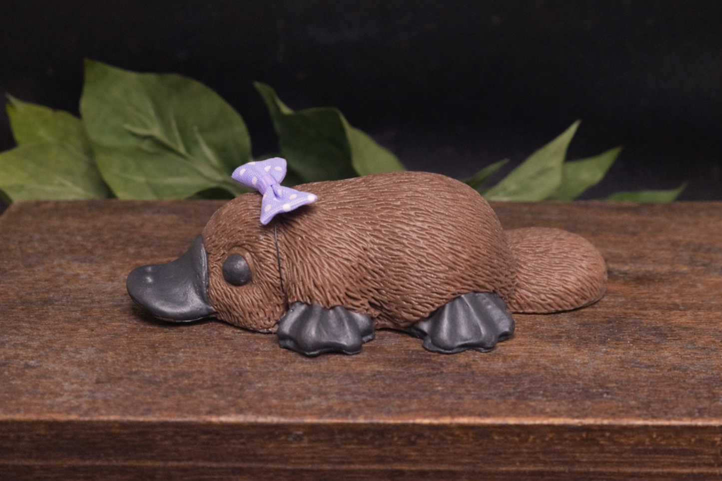 Side view Close up detail of handmade platypus soap texture and bow, artisan goat milk novelty soap