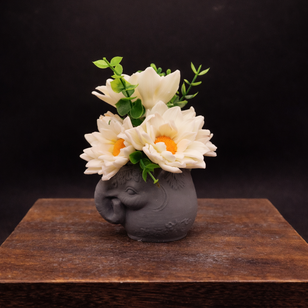 Side view of handmade goat milk soap daisy garden in elephant pot keepsake