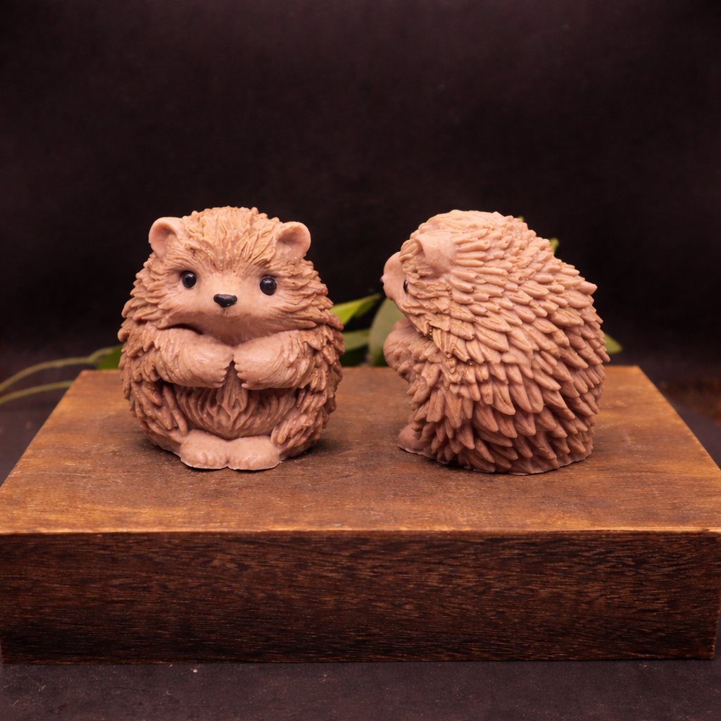 Two large handmade hedgehog goat milk soaps displayed side by side to show scale, sculptural detail, and natural color variation.