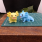 Yellow and blue axolotl goat milk soap keepsake gift, individually handcrafted collectible animal soap displayed  on cutting mat for size 