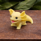 Yellow axolotl goat milk soap keepsake gift, individually handcrafted collectible animal soap displayed on a wooden box with natural greenery.