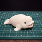 beluga whale handmade goat milk soap on cutting mat to show size of soap
