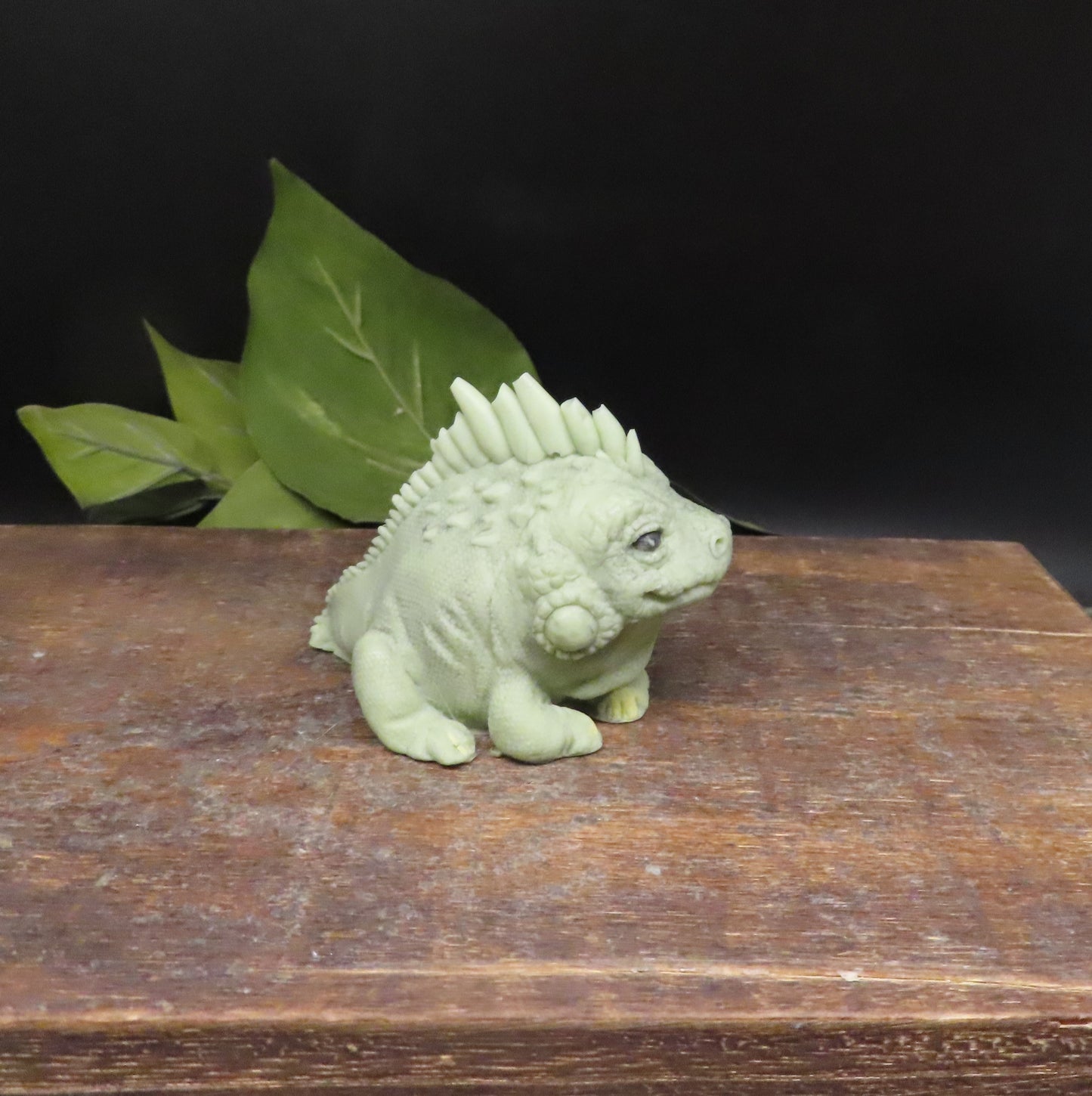 green handmade iguana goat milk soap showing detailed scales, facial features, and textured soap against a clean background.