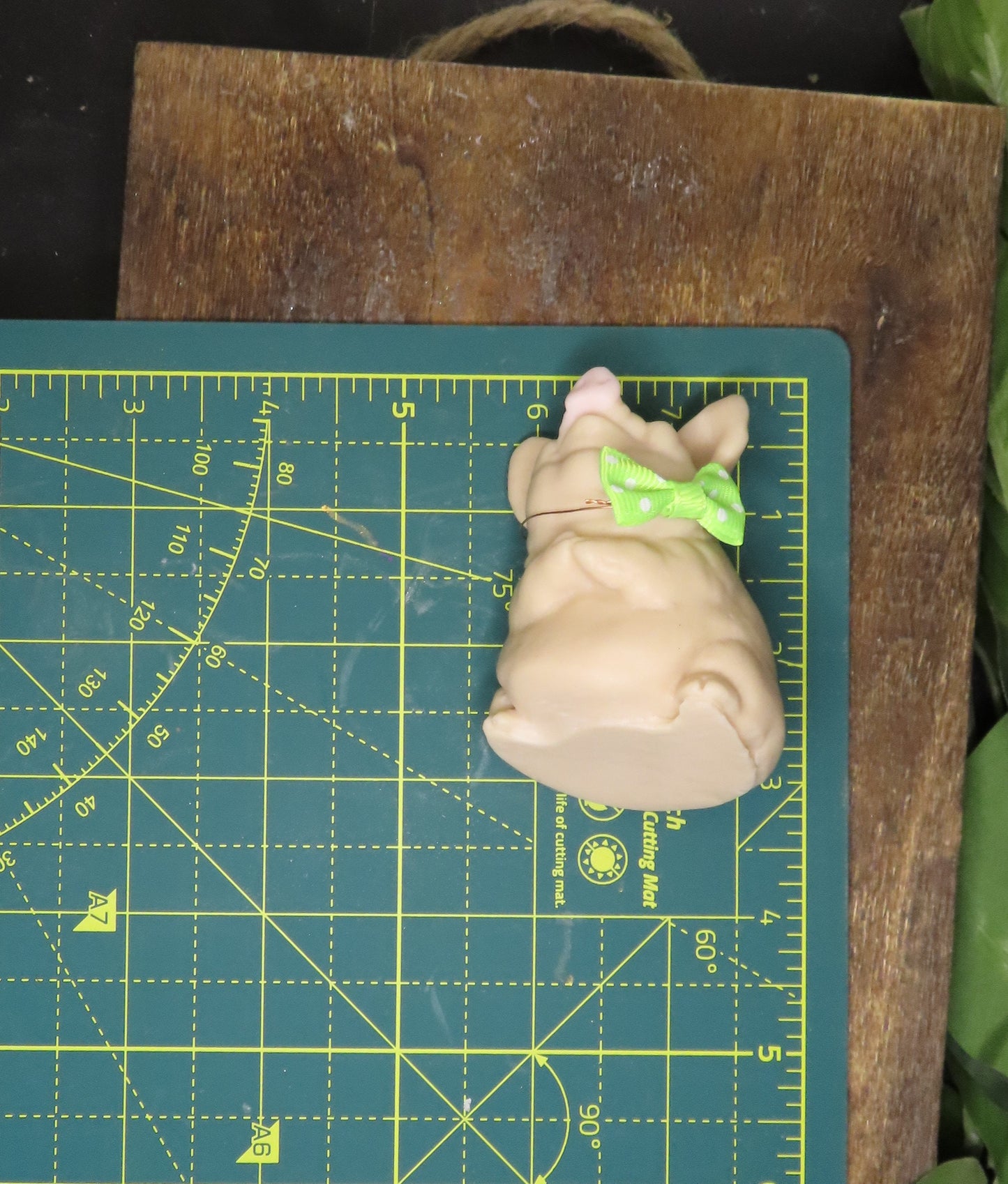 Image of pig goat milk soap on cutting board showing size of approximately 3 inches tall by 1.5 inches wide. 