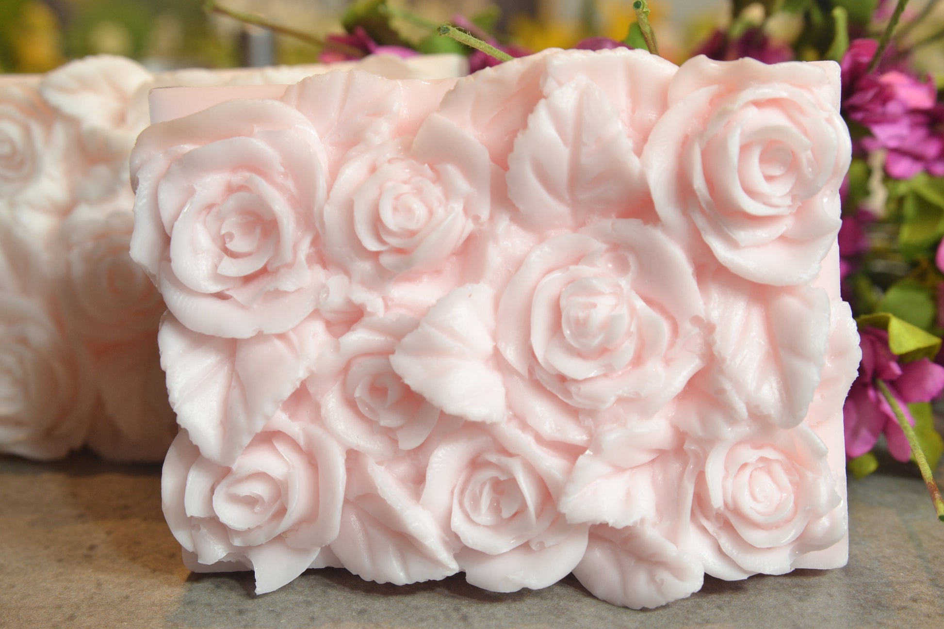 Set of 2 beautifully detailed handmade goat milk soap bars.  Image of pink