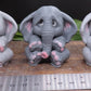 Image of 3 elephant soaps behind a ruler showing width dimention of approximately 2 inches. 